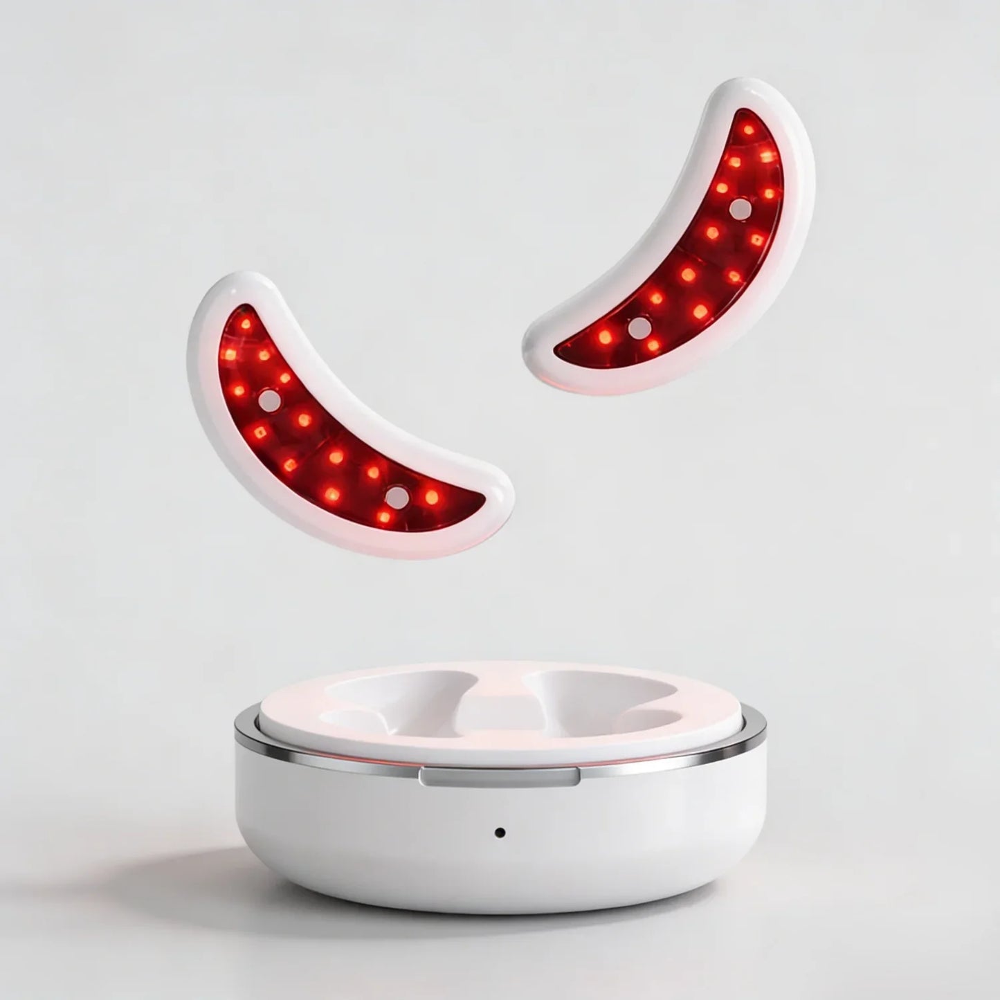 Curved red light therapy devices with LED lights and a white charging base on a plain background