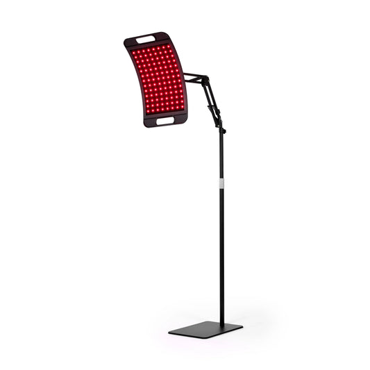 Adjustable red light therapy lamp with stand, LED panel illuminated on white background