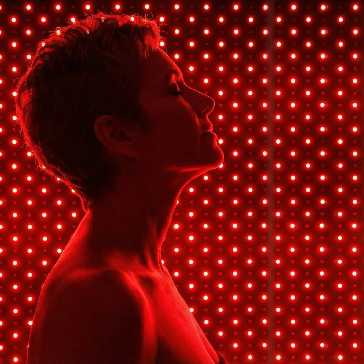 Woman enjoying NiceBeam red light therapy for wellness and self-care at home