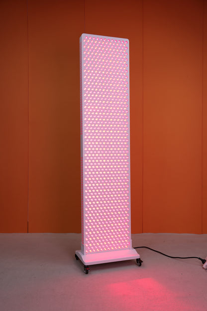 Full-body view of the Nicebeam Red Light Therapy Panel Master, showcasing its tall, rectangular design with 864 glowing LED dual chips emitting therapeutic red and near-infrared light. The panel is mounted on a sturdy rolling base for easy mobility and set against a vibrant orange background.