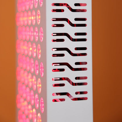Close-up view of the side vent design of the Nicebeam Red Light Therapy Panel, showcasing its intricate pattern for efficient heat dissipation. The glowing red and near-infrared LEDs are visible through the vents, emphasizing the panel&
