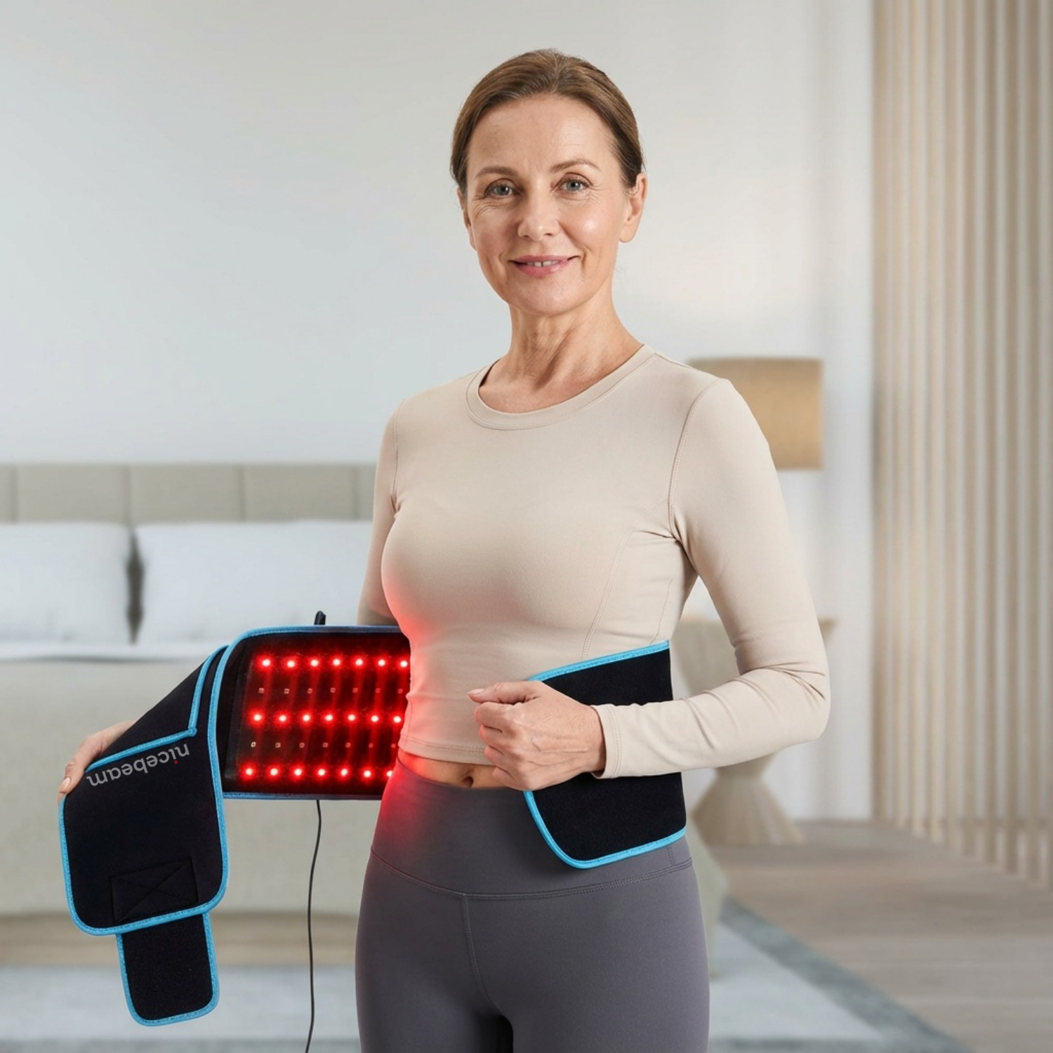 Woman using a red light therapy device in a living room setting