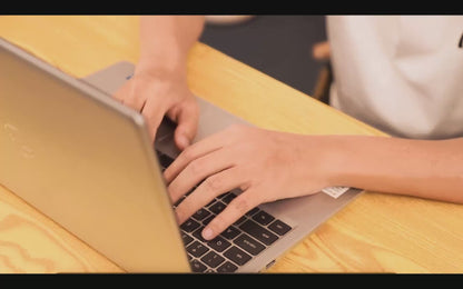 Video demonstration of using red light therapy gloves while typing for effective hand pain relief