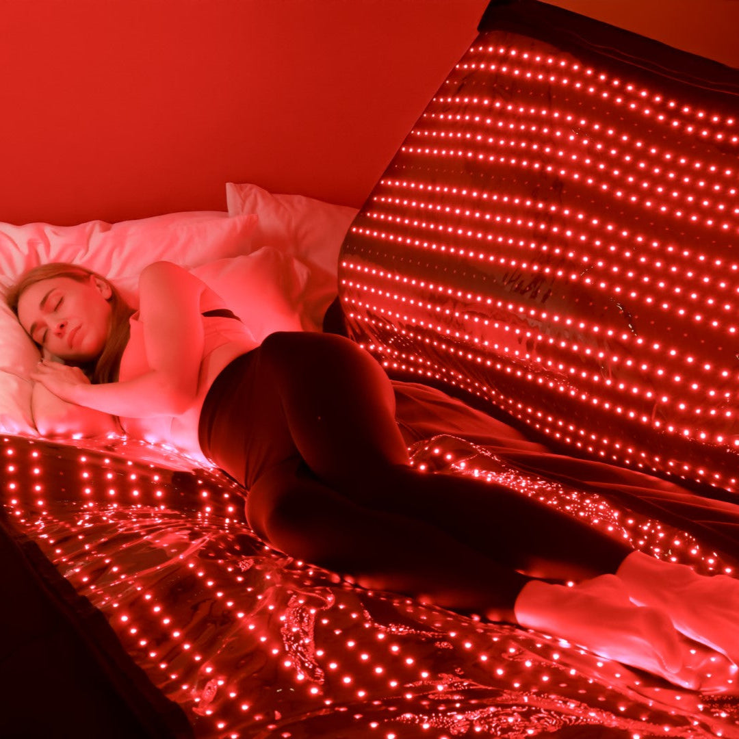 Woman sleeping on a Red Light Therapy Mat, showcasing its benefits for deep relaxation, improved sleep quality, and muscle recovery.