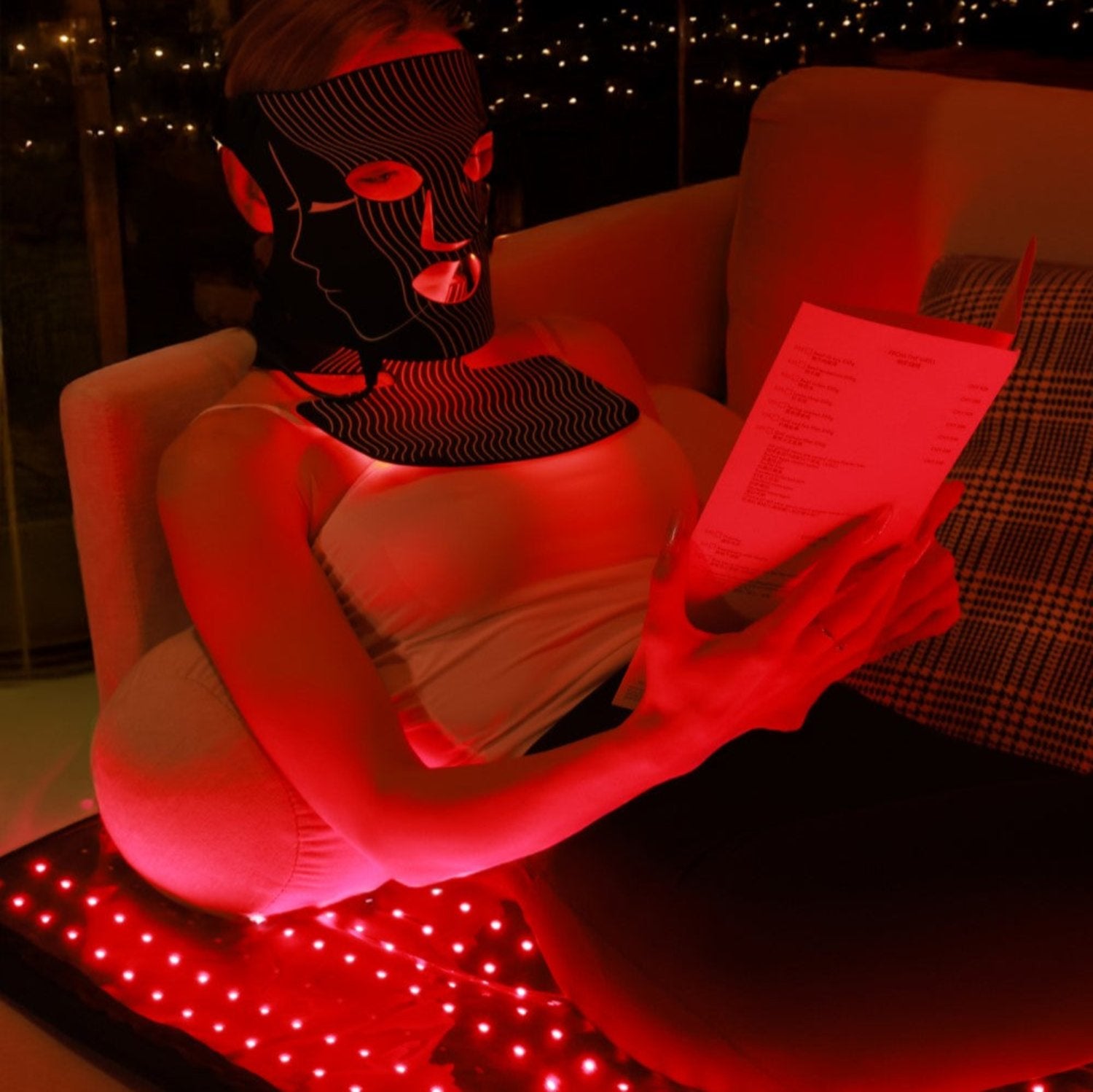 A casual image of a person incorporating red light therapy mask and mat into their daily routine for overall wellness and energy.