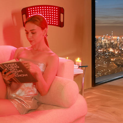 Woman meditating with a red light therapy lamp, promoting relaxation, improved circulation, and holistic wellness.