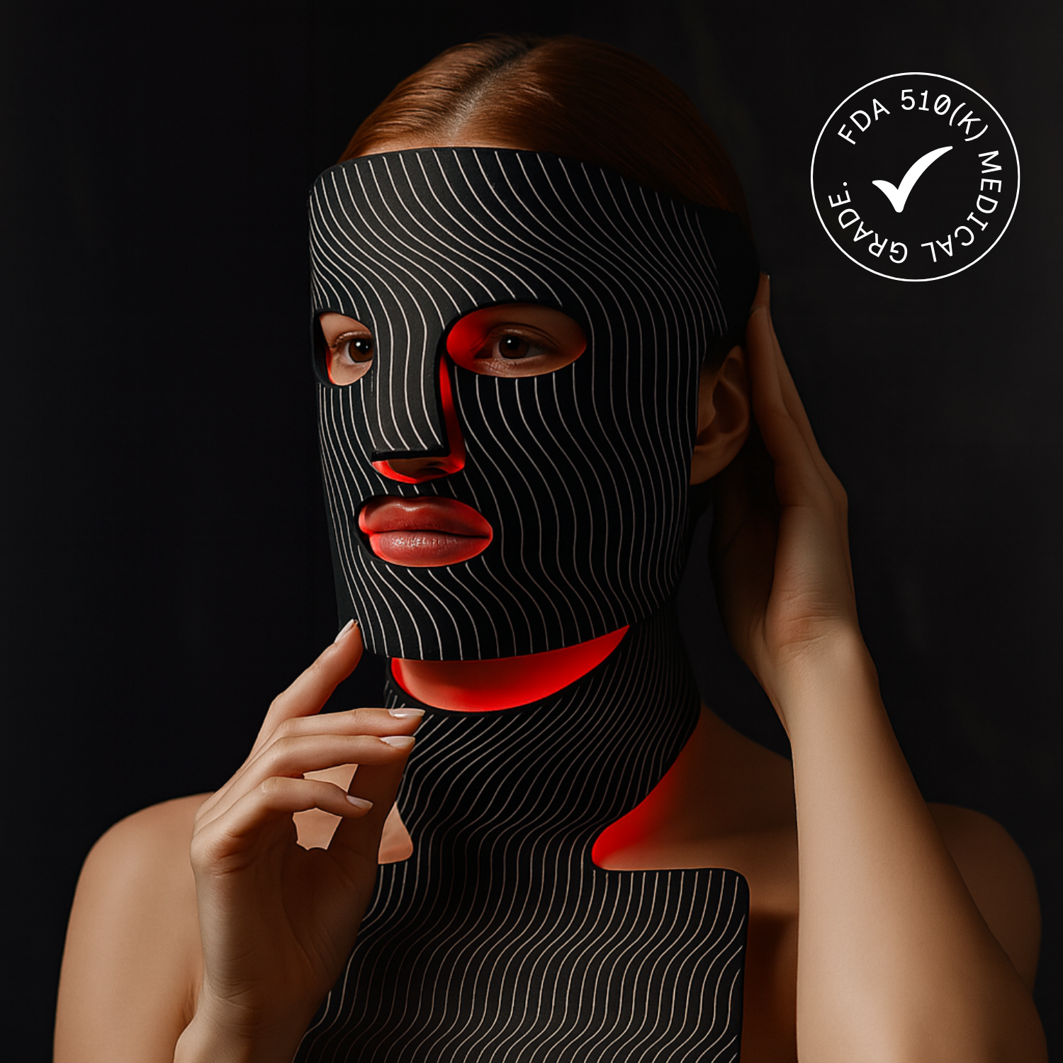 Woman wearing a black and red patterned face mask with FDA approval logo on a dark background