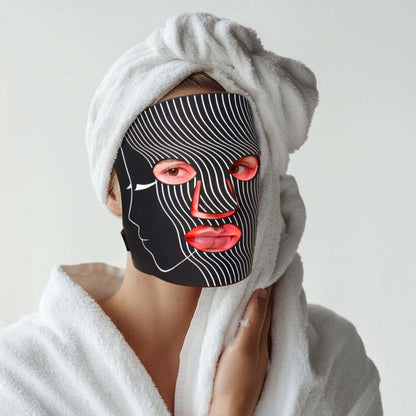 Woman wearing a red light therapy mask in a spa-like setting, emphasizing facial skincare and rejuvenation.