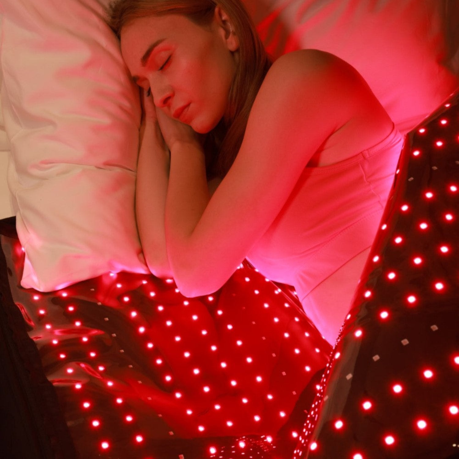 A person using a red light therapy bag 
for muscle recovery, improved blood flow, and wellness, highlighting its portability.